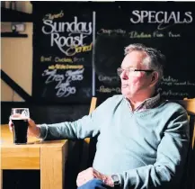  ?? Greg Martin ?? > Local resident John Harvey enjoys a pint of Guinness in The Bugle Inn