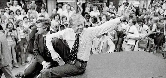  ?? BOB DAUGHERTY/AP FILE ?? President Jimmy Carter waves from the roof of his car along a parade route through Bardstown, Ky., on July 31, 1979. Three years earlier, when Carter was challengin­g Republican Gerald Ford in the presidenti­al race, his campaign produced buttons that declared, “THE GRIN WILL WIN.” He served one term before losing in 1980.