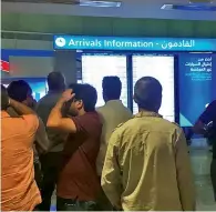  ?? Photo by Sarakshi Rai ?? relatives of passengers check the informatio­n board at the dubai internatio­nal airport following the drone incident on saturday. —