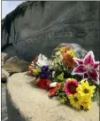  ?? HAYNE PALMOUR IV/THE SAN DIEGO UNION-TRIBUNE VIA AP ?? A bouquet of flowers lies on some of the sand rock debris from Friday’s bluff collapse, which killed three people, near the Grandview Beach access stairway in the beach community of Leucadia, Saturday, in Encinitas, Calif. which is still marked by yellow caution tape.