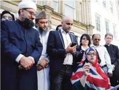  ??  ?? MANCHESTER: Religious leaders speak to crowds during a vigil at St Ann’s square in central Manchester, England yesterday. —AP