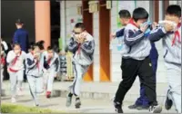  ??  ?? WANG ZHENG / FOR CHINA DAILY Students at a primary school in Huzhou, Zhejiang province, take part in a fire drill on National Fire Prevention Day on Nov 9.