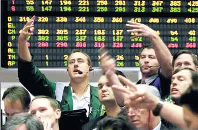  ?? M. SPENCER GREEN / AP ?? Traders at the Chicago Board of Trade work in the wheat options pit.