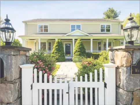  ?? Contribute­d photo ?? Surrounded by stone walls and a white picket fence, this circa 1882 farmhouse colonial is located in the heart of Westport, within walking distance of town, shops and restaurant­s.