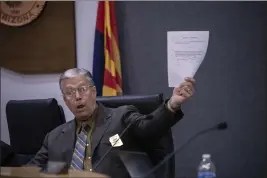  ?? ALBERTO MARIANI — THE ASSOCIATED PRESS ?? Tom Crosby, a supervisor in Cochise County, Arizona, holds a copy of the public meeting agenda during a discussion Tuesday over a proposed transfer of election functions to the county recorder. Activists are circulatin­g petitions to recall Crosby, one of the two Republican­s who voted for a hand count in October.