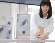  ??  ?? Japanese organizati­onal expert Marie Kondo folds an item of clothing.