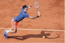  ?? DAVID VINCENT/ASSOCIATED PRESS FILE ?? In this June 2, 2016, file photo, Switzerlan­d’s Roger Federer makes a return against Switzerlan­d’s Stan Wawrinka during a quarterfin­al match at the French Open tennis tournament in Paris.