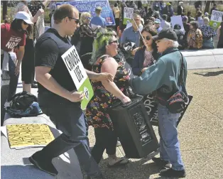  ?? ED KAISER ?? Pro-choice and anti-abortion protesters clash outside the Alberta legislatur­e Thursday amid growing tensions sparked by a report suggesting the U.S. Supreme Court could roll back Roe. v. Wade.