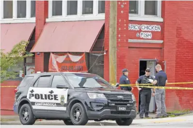  ?? STAFF PHOTO BY C.B. SCHMELTER ?? Police investigat­e a shooting outside the Flaming Rooster restaurant on Brainerd Road last May. Of Chattanoog­a’s 34 homicides last year, 30 were committed with firearms. Year after year, a majority of the city’s homicides are gun-related.