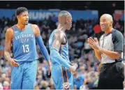  ?? [PHOTO BY BRYAN TERRY, THE OKLAHOMAN] ?? Oklahoma City’s Paul George and Dennis Schroder talk with official Leon Wood after George was called for a foul against Boston on Oct. 25 at Chesapeake Energy Arena.