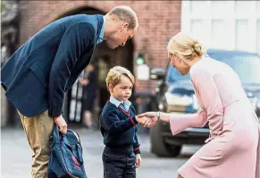  ??  ?? Big day: George accompanie­d by William being met by Haslem at Thomas’s Battersea school. — AFP