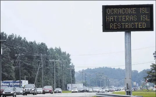  ?? Steve Earley The Associated Press ?? A sign in Moyock, N.C., warns travelers Saturday that access to Hatteras and Ocracoke islands is restricted to residents only.