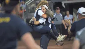  ?? CURT HOGG / NOW NEWS GROUP ?? Whitnall pitcher Haley Wynn jumps into the arms of Mackenzie Sutton after recording the final out of the Falcons' semifinal win.