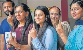  ?? PTI ?? Members of a family show their inked fingers after casting vote for the assembly elections in Karnal district on Monday.