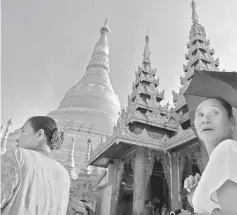  ??  ?? People walk around the Shwedagon Pagoda in Yangon. — AFP photos