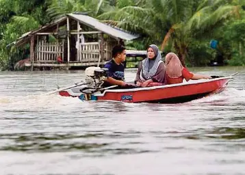  ?? NSTP/NIK ABDULLAH NIK OMAR ?? PENDUDUK kampung terpaksa menggunaka­n perahu untuk keluar menjalanka­n harian dan membeli makanan di Kampung Kajang Sebidang. Antara lebih 10 kampung yang terkesan dan masih digenangi air sehingga paras dua meter (m) berikutan limpahan air dari Sungai Golok. gambar