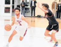  ?? ?? Kwabena Robinson dribbles around Eisenhower’s Ayipey Salinas on Wednesday during the first varsity basketball game on campus at Southland College Prep in Richton Park.