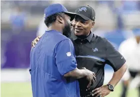  ?? CARLOS OSORIO/ASSOCIATED PRESS ?? Lions coach Jim Caldwell, right, talks with Bills assistant defensive backs coach Ed Reed.