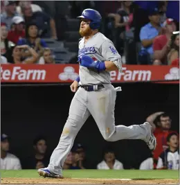  ?? PHOTO BY PAUL RODRIGUEZ ?? The Dodgers’ Justin Turner scores on Hanser Alberto’s triple in the fifth inning Friday.
