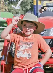  ??  ?? Tipping their hats to Farm World while they test out some of the farm machinery on display are brothers Hamish and Aston Baker who both attend Trafalgar Primary School.