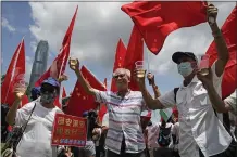  ?? KIN CHEUNG — THE ASSOCIATED PRESS ?? Pro-China supporters holding Chinese national flags toast during a rally in Hong Kong on Tuesday.