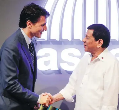  ?? MARK CRISTINO/POOL PHOTO VIA THE ASSOCIATED PRESS ?? Prime Minister Justin Trudeau greets Philippine President Rodrigo Duterte at the Southeast Asian Nations Summit.