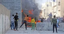  ?? (AFP) ?? Syrian protesters burn a Turkish military vehicle during a demonstrat­ion in Al-Bab on Sunday