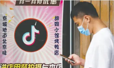  ?? GREG BAKER / AFP VIA GETTY IMAGES ?? The Tiktok logo in the window of a Beijing restaurant this week. The move by the U.S. to ban the Chinese video-sharing app comes amid rising U.s.-china tech tensions.