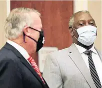  ?? RICARDO RAMIREZ BUXEDA/ORLANDO SENTINEL ?? City of Orlando Mayor Buddy Dyer, left, and Orange County Mayor Jerry Demings talk while wearing their masks before a COVID-19 update press conference on April 13.