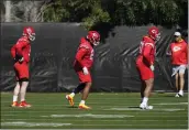  ?? ROSS D. FRANKLIN — THE ASSOCIATED PRESS ?? Kansas City Chiefs offensive tackles Orlando Brown Jr., right, and Lucas Niang, middle, along with guard Joe Thuney, left, warm up during practice in Tempe, Ariz., Friday.