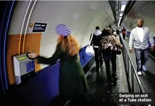  ?? DANIEL BEREHULAK/GETTY IMAGES ?? Swiping on exit at a Tube station