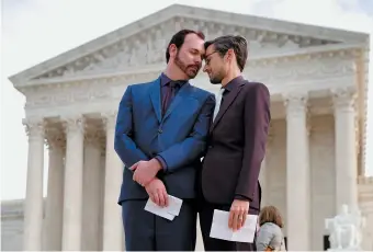  ??  ?? David Mullins and Charlie Craig, the couple who filed a complaint after a Colorado baker refused to sell them a wedding cake, at the Supreme Court, Washington, D.C., December 2017