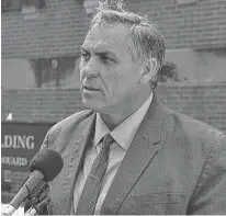  ?? STU NEATBY/THE GUARDIAN ?? Liberal MLA Robert Mitchell, speaking to media outside the Coles Building on Tuesday, said he believes the recent staff layoffs and program cuts are a sign that funding to Holland College needs to be increased.