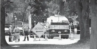  ?? BARBARA HADDOCK TAYLOR/BALTIMORE SUN ?? Traffic is diverted on Tamar Drive near Columbia’s Long Reach Village Center on Monday. Police said a man was shot after he pointed a gun at them during a standoff; the gun was later identified as a replica.