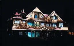  ?? JIM GENSHEIMER — SPECIAL TO BAY AREA NEWS GROUP ?? A spooky light show is projected on the front of Winchester Mystery House in San Jose, site of the immersive attraction “Unhinged.”