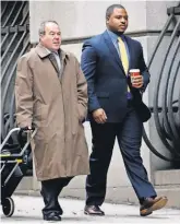  ?? ROB CARR, GETTY IMAGES ?? Baltimore police officer William Porter, right, makes his way to court Monday with his lawyer Joseph Murtha.