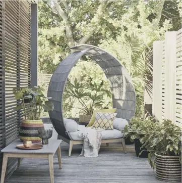  ??  ?? Leia outdoor alcove seat, £559; Leia garden coffee table, £189; Jaipur throw – white, £49; cushions, from £25-£30 each, and black spiky candle holder, £25, all John Lewis.