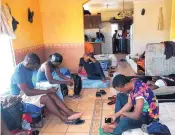  ?? ELLIOT SPAGAT/ASSOCIATED PRESS ?? Cameroonia­ns wait in a rented apartment in Tijuana, Mexico, until their names are called to claim asylum in the U.S.; 10,000 names were on the list last Sunday.