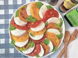  ?? ROBIN MILLER PHOTOS / SPECIAL FOR THE ARIZONA REPUBLIC ?? Caprese salad is a simply perfect combinatio­n of fresh mozzarella, fresh tomatoes and fresh basil with a good drizzle of oil oil and some salt and pepper.