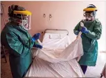  ?? AP PHOTO ?? Nurses in protective gear work in Budapest, Hungary, Monday. Thousands of nurses and doctors in Canada are stepping up to deal with COVID-19