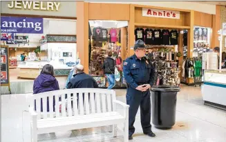  ?? DUSTIN FRANZ FOR THE WASHINGTON POST ?? Security officer Don Howell patrols the Shenango Valley Mall in Hermitage, Penn. The number of stores in the mall is steadily shrinking.