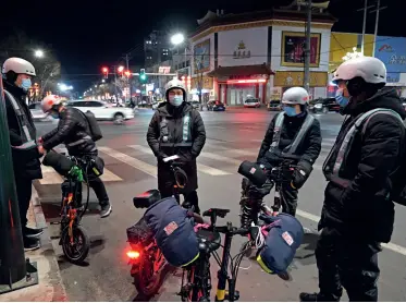  ??  ?? A group of designated drivers in Xiong’an, Hebei Province, are waiting for orders on February 23, 2021.