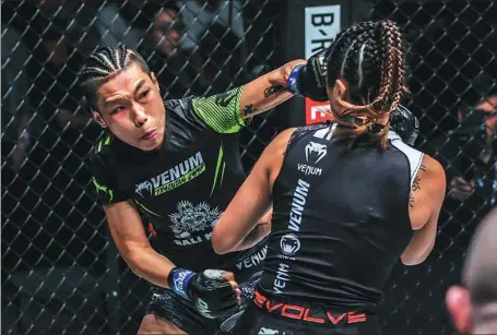  ?? PROVIDED TO CHINA DAILY ?? Chinese MMA fighter Xiong Jingnan (left), pictured here during last October’s One Championsh­ip atomweight world-title bout against Angela Lee in Tokyo, has increased her online engagement with fans during the coronaviru­s pandemic by posting workout videos and training tips on Weibo.