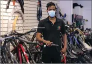  ?? THE ASSOCAITED PRESS ?? Noah Hicks, owner of Spokehouse Bikes in the Upham’s Corner neighborho­od of Boston, poses at his shop. Many from outside Boston have donated to and shopped at the store, which was robbed and vandalized earlier in the month.