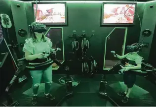  ??  ?? The new venue includes a virtual-reality gaming area that lets gamers drop right into the action on the screen.