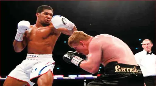  ??  ?? Joshua (left) remains undefeated after his latest knockout victory