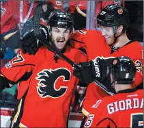  ?? CP PHOTO JEFF MCINTOSH ?? Calgary Flames' Michael Frolik, left, from the Czech Republic, celebrates his goal with teammate Dougie Hamilton during first period NHL hockey action against the New York Islanders in Calgary, Sunday.