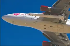  ?? PATRICK T. FALLON /AFP VIA GETTY IMAGES ?? The Virgin Orbit “Cosmic Girl” — a modified Boeing Co. 747-400 carrying a Launcheron­e rocket — takes off from Mojave Air and Space Port on Sunday in Mojave, Calif.