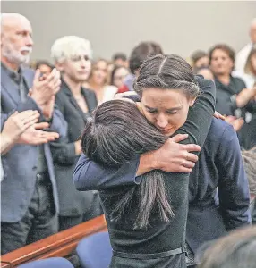  ?? JENNA WATSON/USA TODAY NETWORK ?? Rachael Denholland­er, right, embraces Kaylee Lorincz, survivors of sexual abuse by Larry Nassar, in court Wednesday.