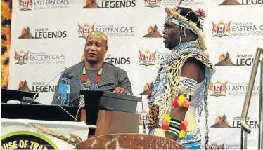  ?? Picture: LULAMILE FENI ?? LET’S UNITE: Imbongi Sincedile Mngomeni sings songs of praise while Eastern Cape premier Phumulo Masualle takes to the podium to deliver his speech during the opening of the Eastern Cape House of Traditiona­l Leaders in Bhisho on Thursday.